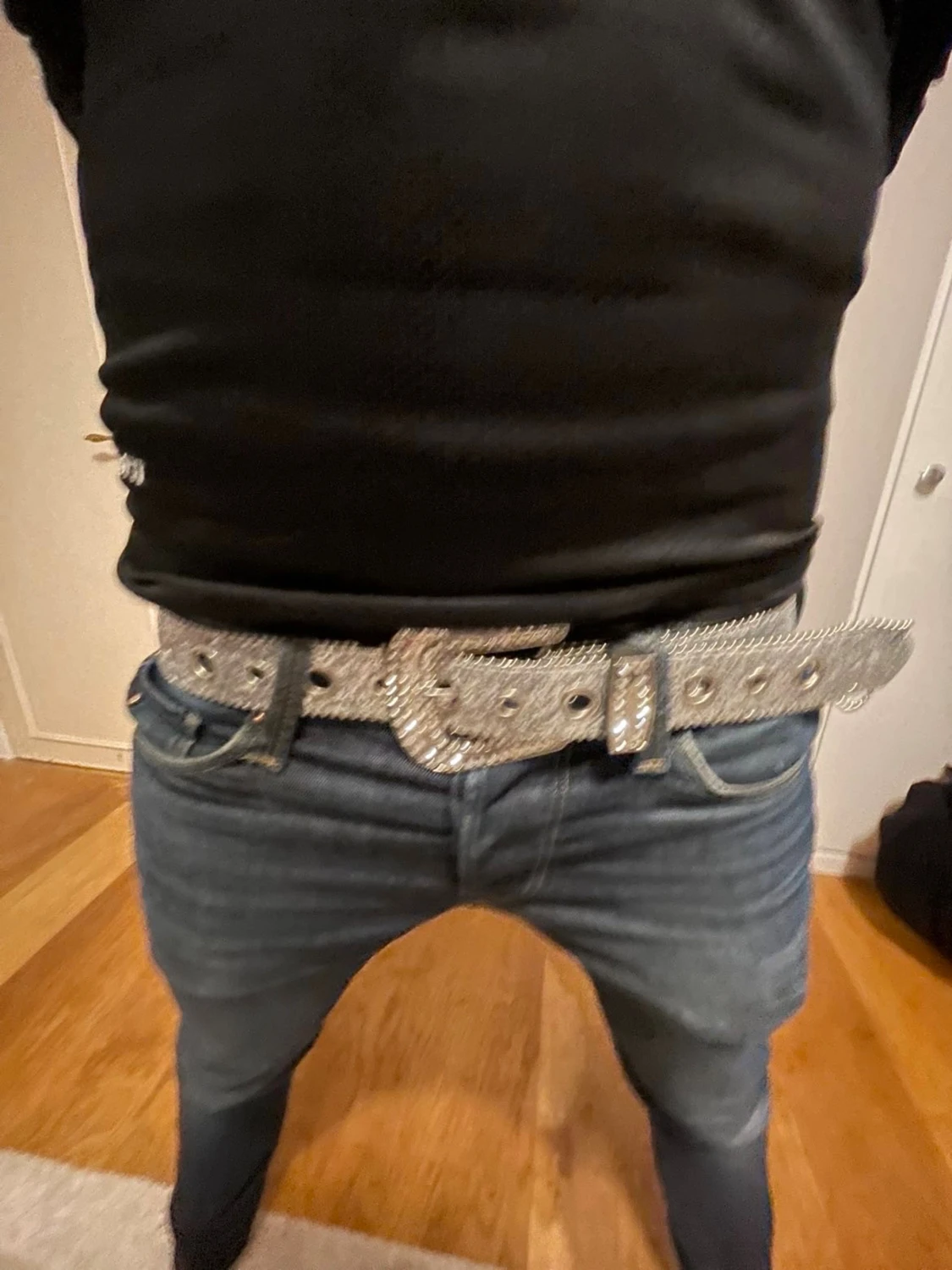 Glittrigt silverbälte med stora nitar