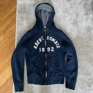 Abercrombie & Fitch Zip Up Hoodie - A&F hoodie i mycket bra och tung kvalitet. Skicket är bra och som på bilderna. Hör gärna av er vid ytterligare frågor.