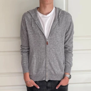 Grå kashmir hoodie från Sayless - Säljer nu min Kashmir tröja från sayless eftersom att den inte används mer. Modellen på bilden är 186cm lång, väger 70kg och när storleken M, tröjan sitter perfekt på mig. Skicket är 7,5/10 eftersom att det är hål på båda armbågarna. Dem går förmodligen att sy ihop på ett snyggt sätt ifall man är intresserad. Tröjan kostade 2000kr i nypris och dem säljs inte mer.Tveka inte på att kontakta oss  vid frågor eller funderingar. Pris kan gå ner vid snabb affär. 