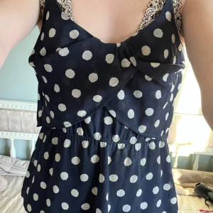 Prickigt linne - Snyggt polka dot linne-blus i mörkblå och vit. Linnet har tunna axelband och är lite tajtare i bysten och lite större runt magen. Storlek S och kommer från Lindex ”Holly & White”. Pris går att diskuteras