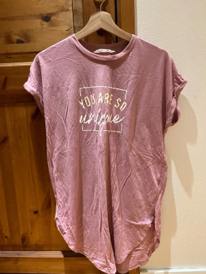 Rosa nattlinne - Rosa nattlinne från Primark i storlek 38/40. Sparsamt använd. Har även en text på framsidan där det står ”You are so uniqe”, svenskt översatt: Du är så unik. Något nopprig på tyget men i övrigt bra skick. Djur och rökfritt hem.