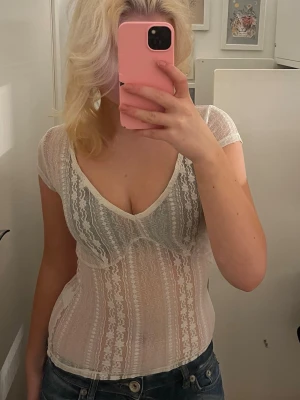 Vit spetsig topp  - Säljer en  vit topp med genomskinlig spets från Nelly💗