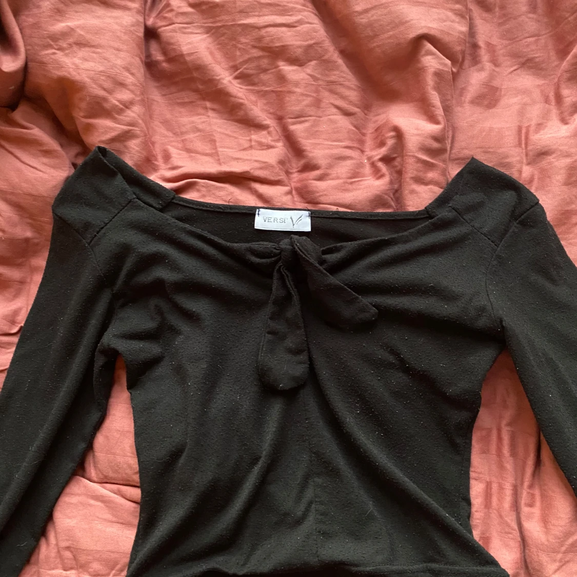 Svart långärmad topp med knyt från Versi Nopprig strl M