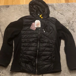 Parajumper Cardigan NYSKICK - Hej, säljer en svarta cardigan från Parajumpers med luva, ficka på bröstet och nere vid ryggen. PJS-logga på ärmen. Den skulle vara en present, men slutade med att den var för liten. Den passar L-XL eftersom det är slim fit. Priset: 1700kr. Ettiket samt kvitto finns kvar. Pris kan diskuteras vid förfrågning!