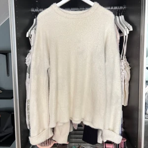 Vit fluffig stickad tröja - Supermjuk och skön och lite oversized vit stickad tröja med fluffig känsla. Storlek M med domsagor lite oversize kommer dock tyvärr ej ihåg vart ifrån!! Jättesnygg till hösten 