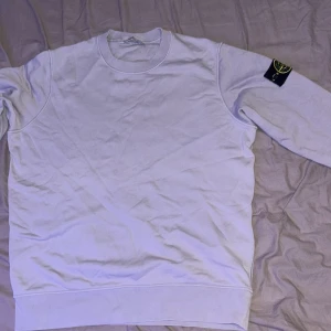 Grå Stone Island sweatshirt. - Grå Stone Island tröja i nyskick. Perfekt för finare tillfällen men även perfekt till vardagliga användningar. Den är grå men även har en gnutta blåaktighet i sig. Väldigt stilren och snygg.