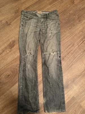 Grå slitna jeans från Dolce & Gabbana - Dolce & Gabbana jeans i strl 33, lite slitna men inget som är sönder. 