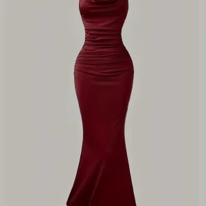 Vinröd långklänning med tight passform - Supersnygg vinröd långklänning i figurnära modell med markerad midja och lätt utsvängd nederdel. Klänningen har ärmlös design, rundad hals och snygga rynkade detaljer längs sidorna. Tillverkad i mjuk och stretchig polyester som sitter perfekt.