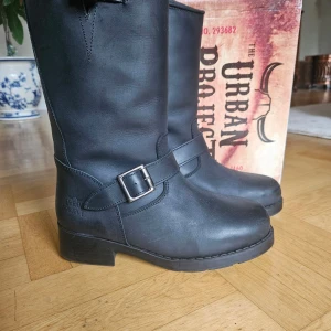Svarta boots från Urban Project - Svarta boots i skinn från Urban Project med grov sula och rund tå. Insidan är fodrad med mjuk päls för extra värme. Provade utomhus 10 minuter, köpt för 1800:-