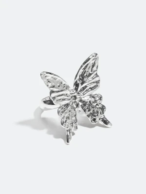 Silvrig ring med fjärilsdesign - Stilren ring med stor fjäril i hamrad design. En dekorativ ring som adderar det lilla extra till din look. Köpte fel storlek så helt ny och oanvänd.