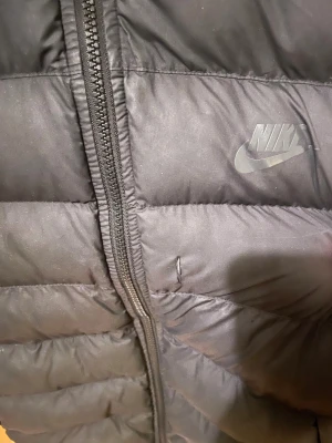 nike vinterjacka - säljer min nikevinterjacka då den blivit för liten. den har två små defekter, se bild. Men de syns knappt. Storlek står inte men passar xs och mindre. Skriv för fler bilder
