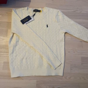 Vit kabelstickad tröja Polo Ralph Lauren - Snygg helt ny med taggar helt oanvänd vit kabelstickad tröja från Polo Ralph Lauren. Perfekt till alla säsonger 10/10 skick skriv gärna om du har några funderingar 