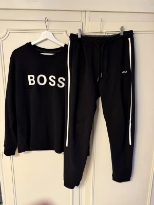 Svart BOSS komplett - Svart komplett från BOSS i storlek M. Varan är i nyskick bara legat i garderoben
