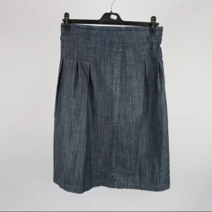 Mörkblå kjol från Wera i bomull - Snygg mörkblå kjol från Wera med lätt utställd form och diskreta veck framtill. 