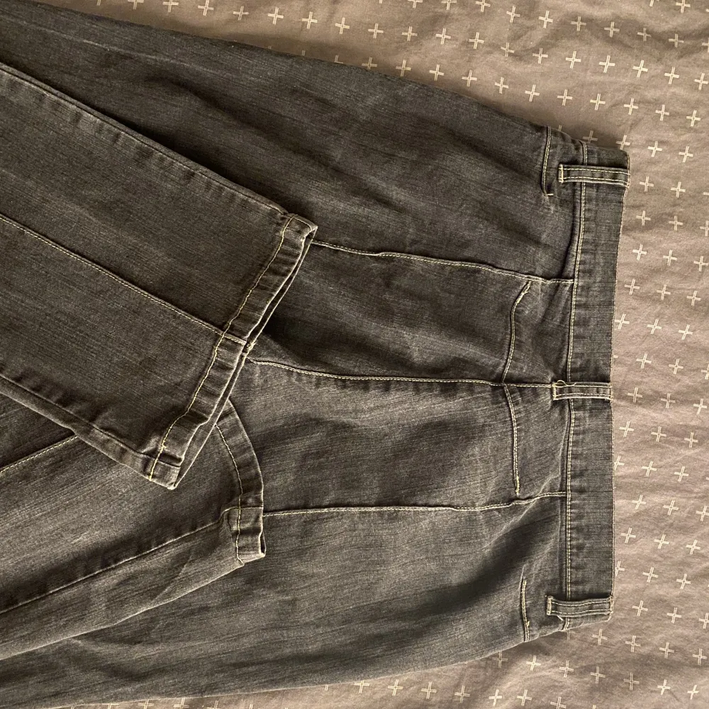 Ett par mörkgråa low waist jeans. Bra skick förutom att det finns 1 litet hål längst ner  på varje byxben men svårt att se. Det finns inga bakfickor. Skönt material. Jeans & Byxor.