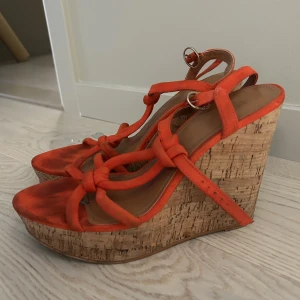 Kilklackar i röd/orange från H&M - Kilklackar från H&M i strl. 39. I gott, använt skick.
