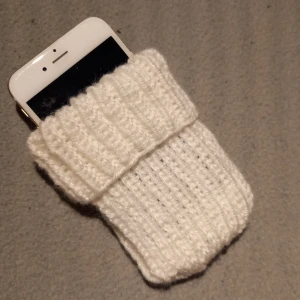 Värmande mobilfodral som passar de flesta - Ett värmande och skyddande fodral för mobilen - som förlänger batteritiden. Passar de flesta telefoner. Fodralet är 16×7,5 cm, men töjbart på bredden. Kan tvättas i 40 grader.
