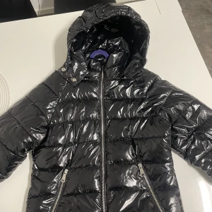 Nelly glansig jacka - Säljer min fina glansiga jacka från Nelly, den är slutsåld på hemsidan, köpt för ca 1 mpnad sen och knappt använd, därav säljs den. Strl 38 utan skador❤️