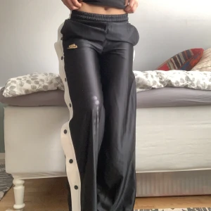 Nike byxor  - Sköna Nike byxor som knappt är använda. Det är knappar på sidorna som går att knäppa upp samt resår och snören i midjan. 