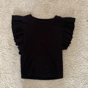 svart volang topp zara ❤️‍🔥 - säljer denna söta toppen från zara 💞 den är i fint skick !💓kontakta mig för fler bilder eller intresse 💋(är inte säker på om jag vill sälja den, vill se vad jag kan få för den💖)
