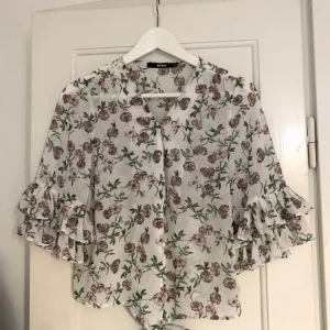 Blus - Vacker blus med blom-mönster och knapp detaljer