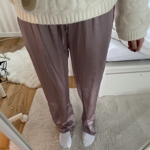 Pyjamasbyxor  - Satin pyjamasbyxor som är super sköna. De är rosa/lila. De är storlek L men jag skulle säga att de passar både S och M beroende på hur man vill att de ska sitta. 