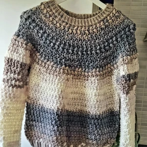 Handstickad tröja stl. XS-S - En välgjord grovstickad tröja gjord för hand! Storleken kan bedömas till XS/S, asymmetriskt mönster med vitt, blått och grått. Passformen är någonstans mitt emellan tajt och normal. Väldigt mjuk i texturen. Fint skick med fin känsla av att vara hemarbetad