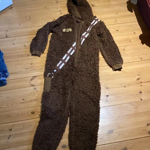 Chewbacca pyjamas  - Säljer en Chewbacca pyjamas då den nästan aldrig kommit till användning, passformen är för både killar och tjejer i åldrar 13-14 år. Har förvarats i djur och rökfritt hushåll.