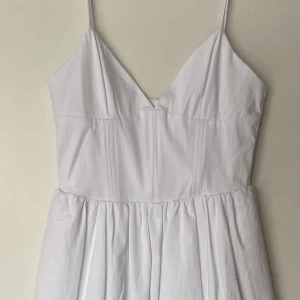 Studentklänning - Superfin vit korsett-klänning från Zara, passar perfekt som studentklänning eller examensklänning. I storlek S. Aldrig använd tagg finns kvar. Skriv om du har frågor eller vill ha flera bilder!! (klänningen har shorts under)