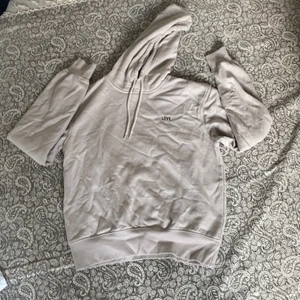 Hoodie - En fin ljus brun hoodie med ett tryck som det står LOVE på! Inge använt mycket och den har Inge fläckar!