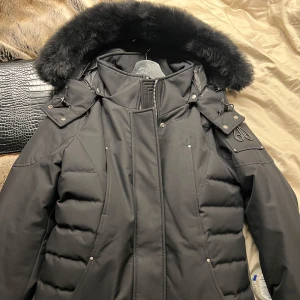 Moose knuckles jacka dam - Utmärkt nytt skick. Köpte under sommaren och gick ned i vikt så jackan blev för stor för mig. Har använt max 2 gånger, storlek M och figursydd. Nyaste cloud modellen för dam med svart päls. Kvitto kan finnas hemma hos mina föräldrar, jackan är äkta. Kan gå ned i pris vid snabb affär