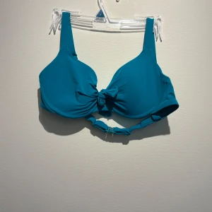 Turkos bikini från Calzedonia - Snygg turkos bikini från Calzedonia med vadderad bygel-bh och knyt i mitten. Underdelen har höga sidor och knytband i midjan för en trendig look. Perfekt för strandhäng och poolparty! Materialet är mjukt och stretchigt syntet för bästa komfort.