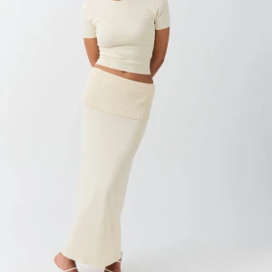 Beige stickad långkjol -  beige långkjol i stickat material med bred ribbad midja, från Gina tricot. Helt ny med lappen kvar