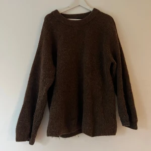 Brun stickad tröja med loose fit - Mysig brun stickad tröja med avslappnad passform och rund hals.