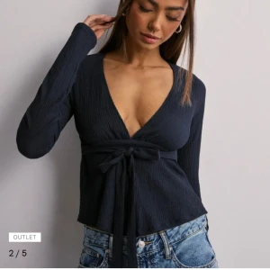 Mörkblå omlottopp med knyt - Säljer en supersnygg långärmad topp från Nelly använd ett fåtal gånger💕 toppen är slutsåld på hemsidan💕