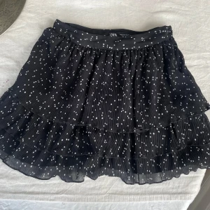 Svart volangkjol /shortsshol med prickar från Zara - Supersöt svart kortkjol med inbyggda shorts i från Zara med vita prickar och flera volanger.   Finns inte kvar i lager någonstans. Passar tilll allt.🖤🖤