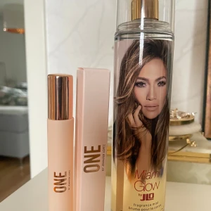 Parfymset ONE & Miami Glow JLO mist  - Säljer två parfymer från Jennifer Lopez: ONE 9,5ml edp by JLO i en matt ljusrosa flaska med guldfärgat lock och matchande ask, samt Miami Glow mist by JLO i en hög, transparent flaska med guldigt sprayhuvud och motiv, 240ml. Perfekt för dig som gillar fräscha och tropiska dofter. Testat ett sprut utav parfymen. Misten är oanvänd!