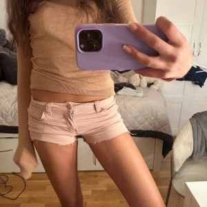 Ljusrosa jeansshorts från ONLY - Säljer ett par ljusrosa jeansshorts från ONLY med låg midja och råa kanter som är klippta 💕💕💕
