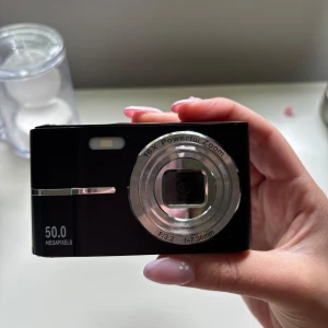 Digitalkamera - Säljer denna digitalkamera för den inte kommer till användning!  50 megapixlar och 2.7 videoupplösning. Den är i nyskick, bara använd en gång. Det som ingår är: kameran, box, tygpåse, laddare. Minneskort ingår ej! 