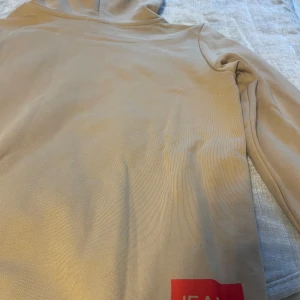 Beige Calvin Klein tröja - Säljer en snygg beige Calvin Klein tröja som är helt oanvänd och har prislapp kvar! Dock har det kommit någon liten fläck på baksida tröja kan nog gå bort i tvätten elr med lite vatten. Hör av er vid fler frågor 💕storlek 164 passar xs-s