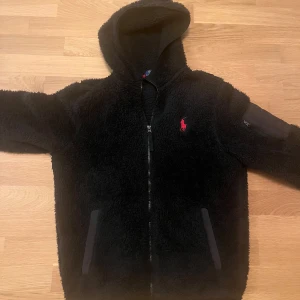 Svart teddyjacka med huva från Ralph Lauren - Säljer en skitfet Ralph lauren fleece . Den är använd ett par gånger och är i bra skick. 