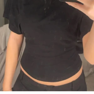 Svart kortärmad topp från Nelly - Snygg svart topp från Nelly med korta vida ärmar och rund hals. Använd 2 gånger 