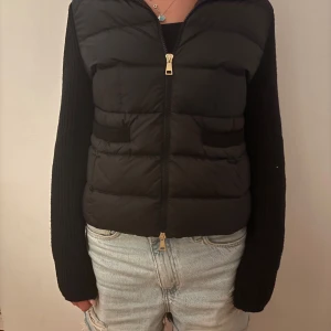 Svart cardigan från Moncler - Säljer en svart dunväst från Moncler med klassisk logga på ärmen. Köpte den i våras men kommer inte till andvändning!