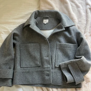 Grå kappa  - Säljer denna otroligt snygga kappan från Kappahl som tyvärr inte kommit till användning! Endast använd 2 gånger. Storlek XS. Köpt för 900 men säljer för 325!
