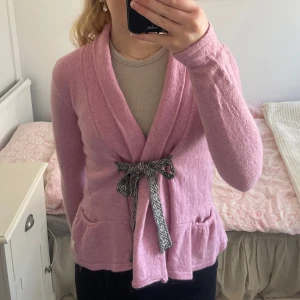 Rosa kofta från Odd Molly - Säljer en söt rosa kofta från Odd Molly med broderad kompassdetalj på ryggen. Koftan har långa ärmar och knytband framtill. Perfekt för en mysig dag!