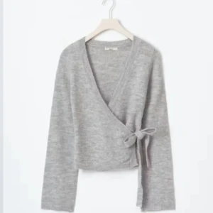 Grå omlottkofta med knytband - Säljer en jätte fin omlottskofta från Gina tricot💗 Den är i storleken M men passar mig som är XS-S. Inga defekter bara använder den inte så mycket!💗