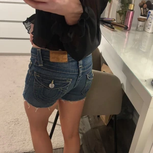 Blå jeansshorts från True Religion - Säljer ett par klassiska blå jeansshorts från True Religion. Dem är i storlek 7 så dem är ganska små. 