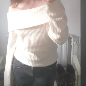 Offshoulder ribbad tröja från H&M - Säljer en vit ribbad offshoulder-tröja från H&M. Tröjan har lång ärm och bred krage som sitter snyggt över axlarna. Perfekt för dig som gillar en stilren och trendig look.
