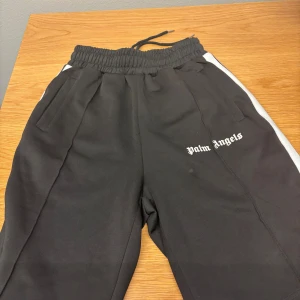 Svarta shorts från Palm Angels - Snygga svarta shorts från Palm Angels med vita sidoremsor. Väldigt sköna och i storlek S fast skulle säga att dem mer är M-L. Kontakta vid minsta intresse