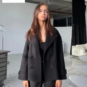 Svart kappa med knappar - Snygg svart kappa med dubbelknäppning och bred krage. Skriv om du vill se fler bilder 